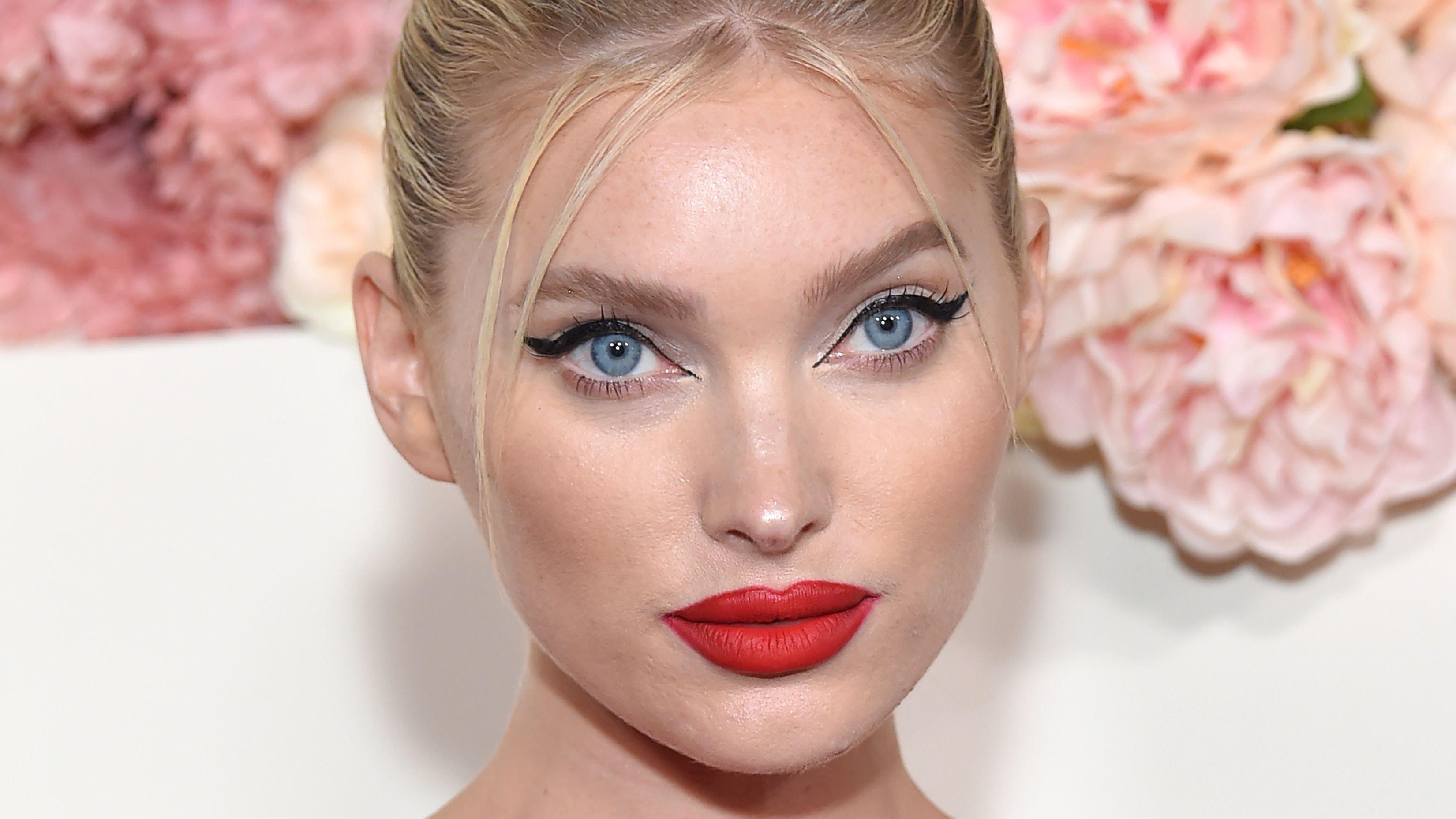Elsa Hosk rocks bold red lip and pulled-back hair at an event.