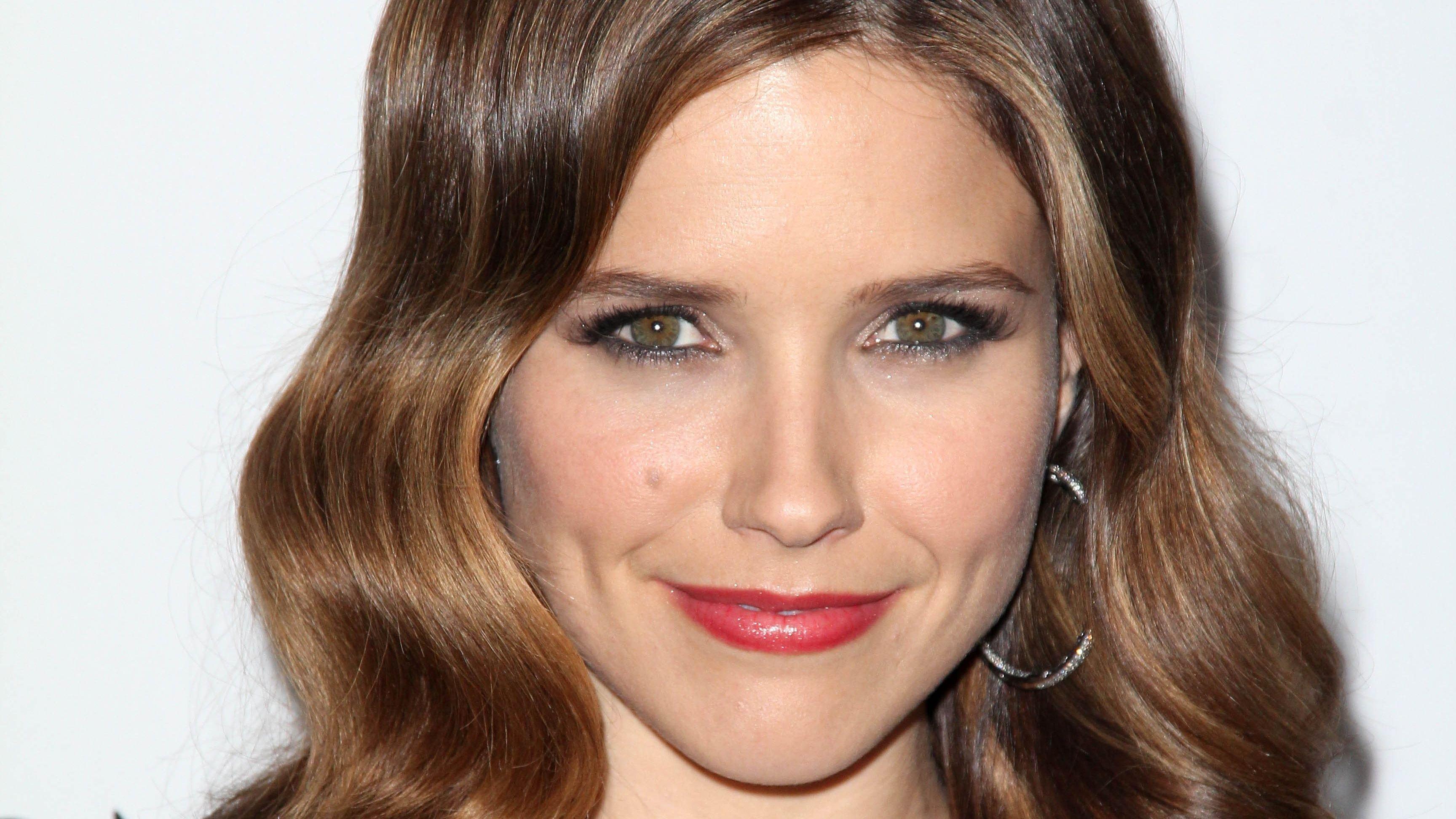 Sophia Bush smiles with curls and red lipstick
