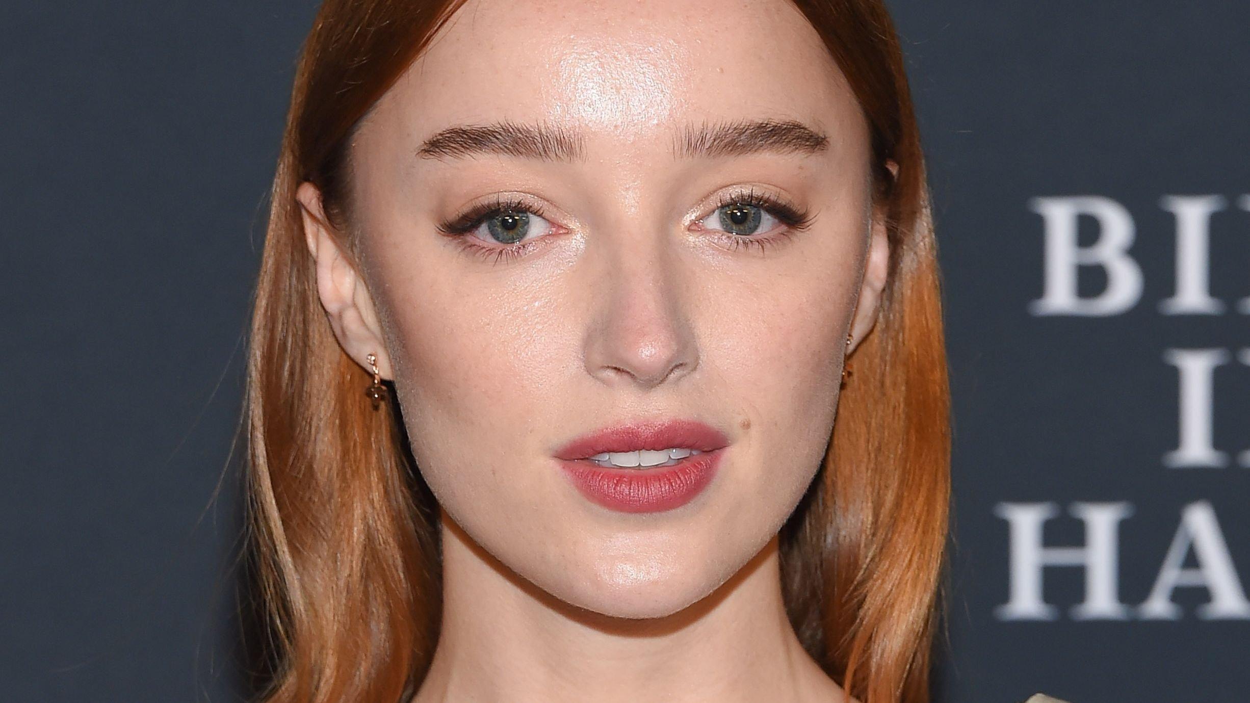 Close-up of Phoebe Dynevor with red hair and rose-pink lipstick.