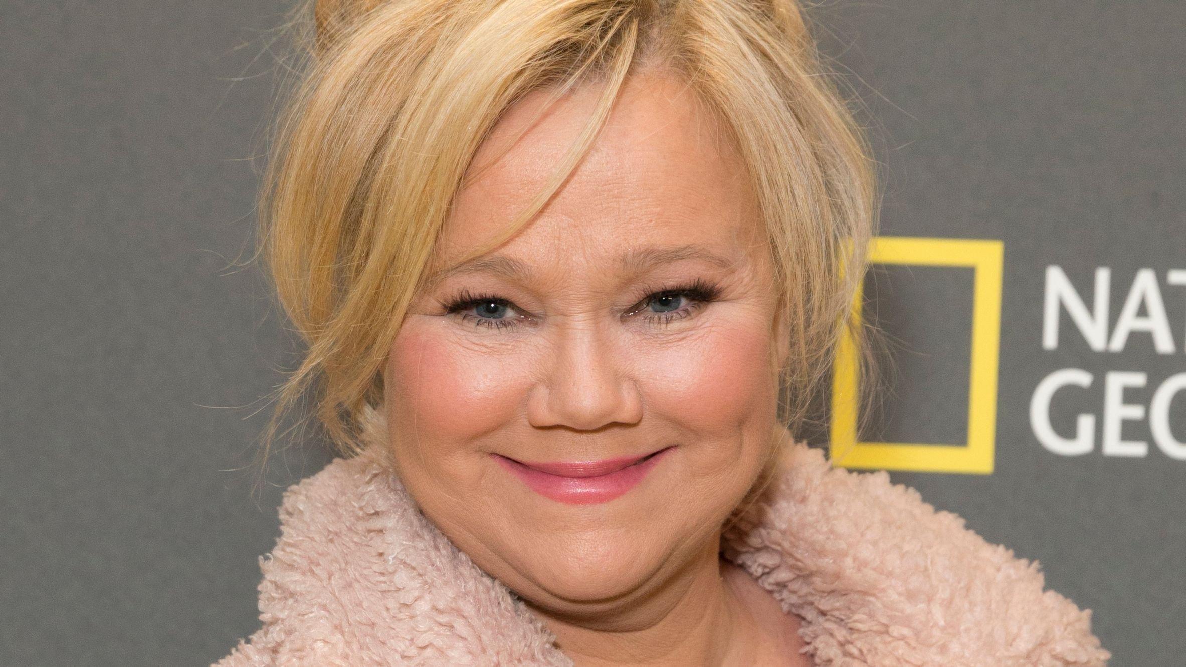 Caroline Rhea smiles with hair to the side