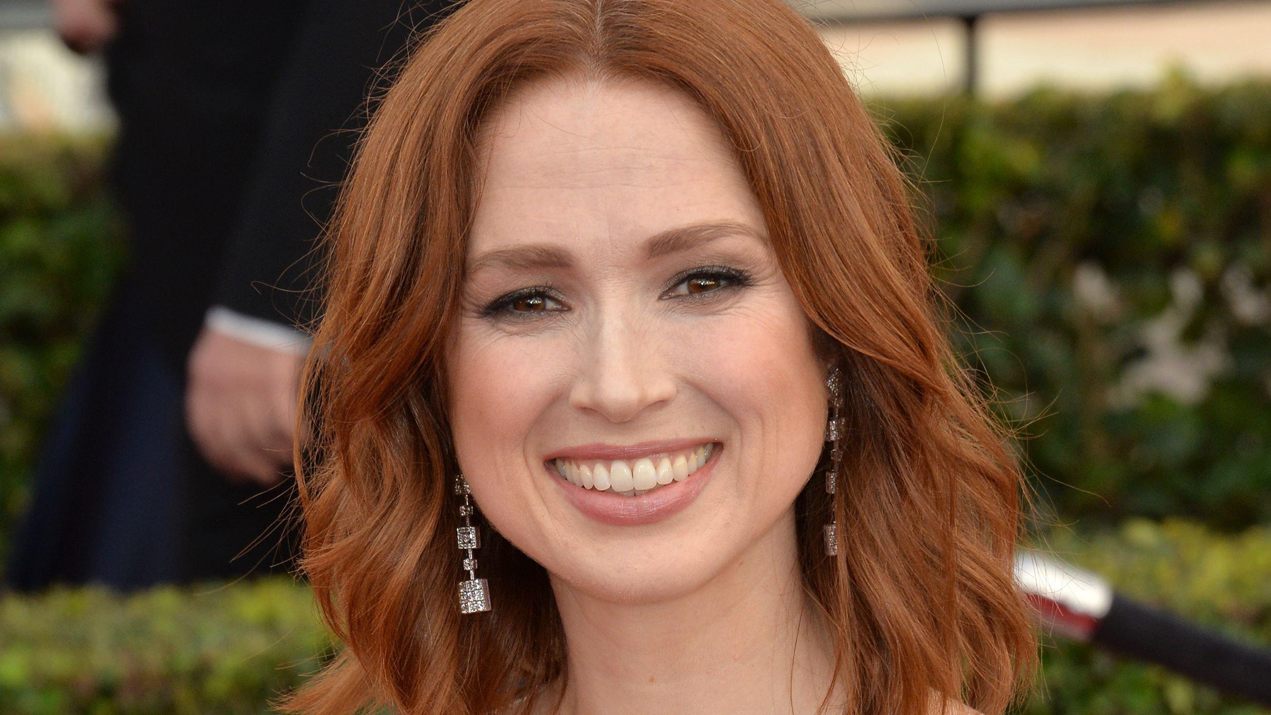 Ellie Kemper smiles with short red hair