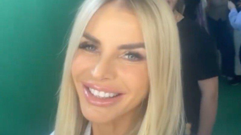 Alexia Echevarria smiles in white robe with straight hair