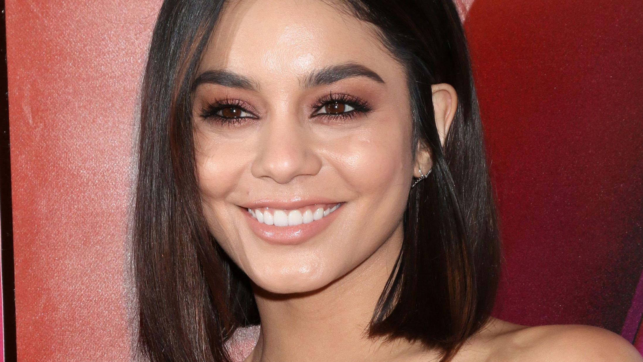 Vanessa Hudgens with short hair smiling for a photograph.