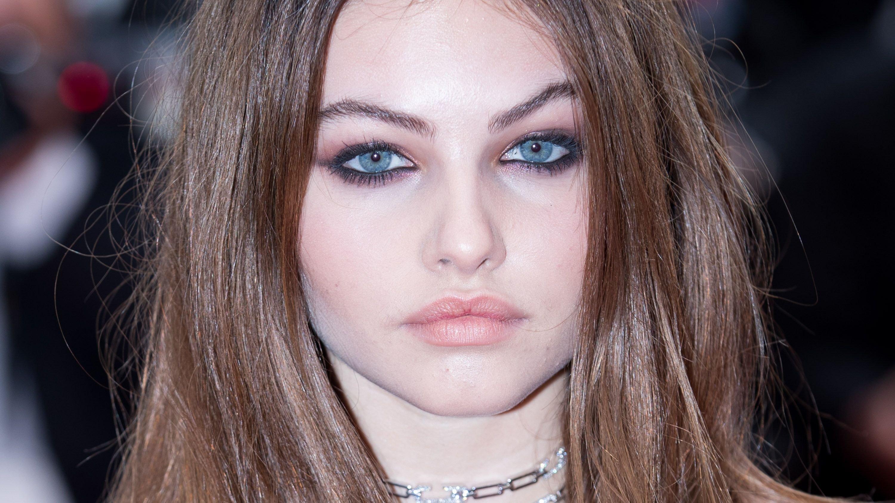 Close-up of Thylane Blondeau with her hair down and a silver chain choker.