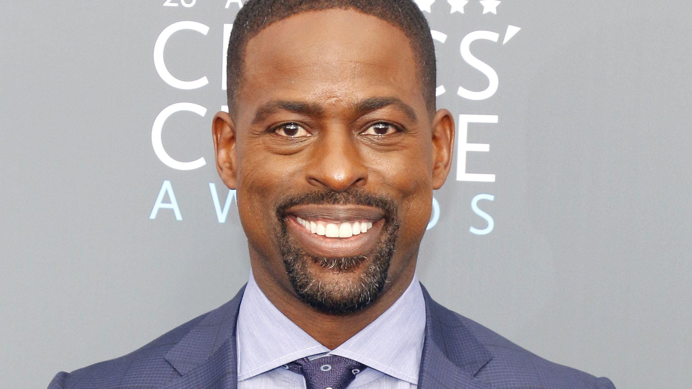 Sterling K Brown in blue suit and tie
