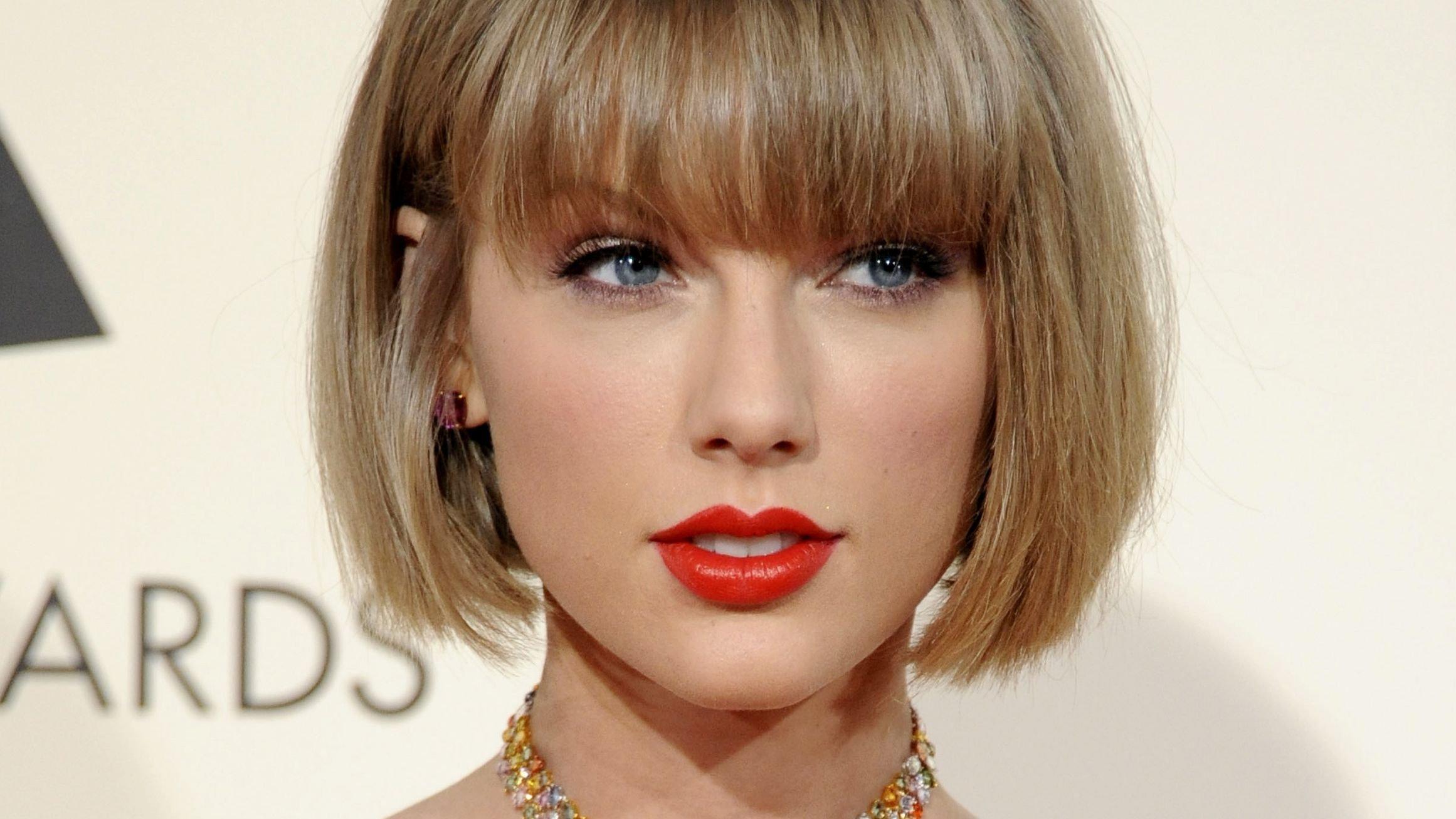 A close up photo of Taylor Swift with a chin length bob and bangs.