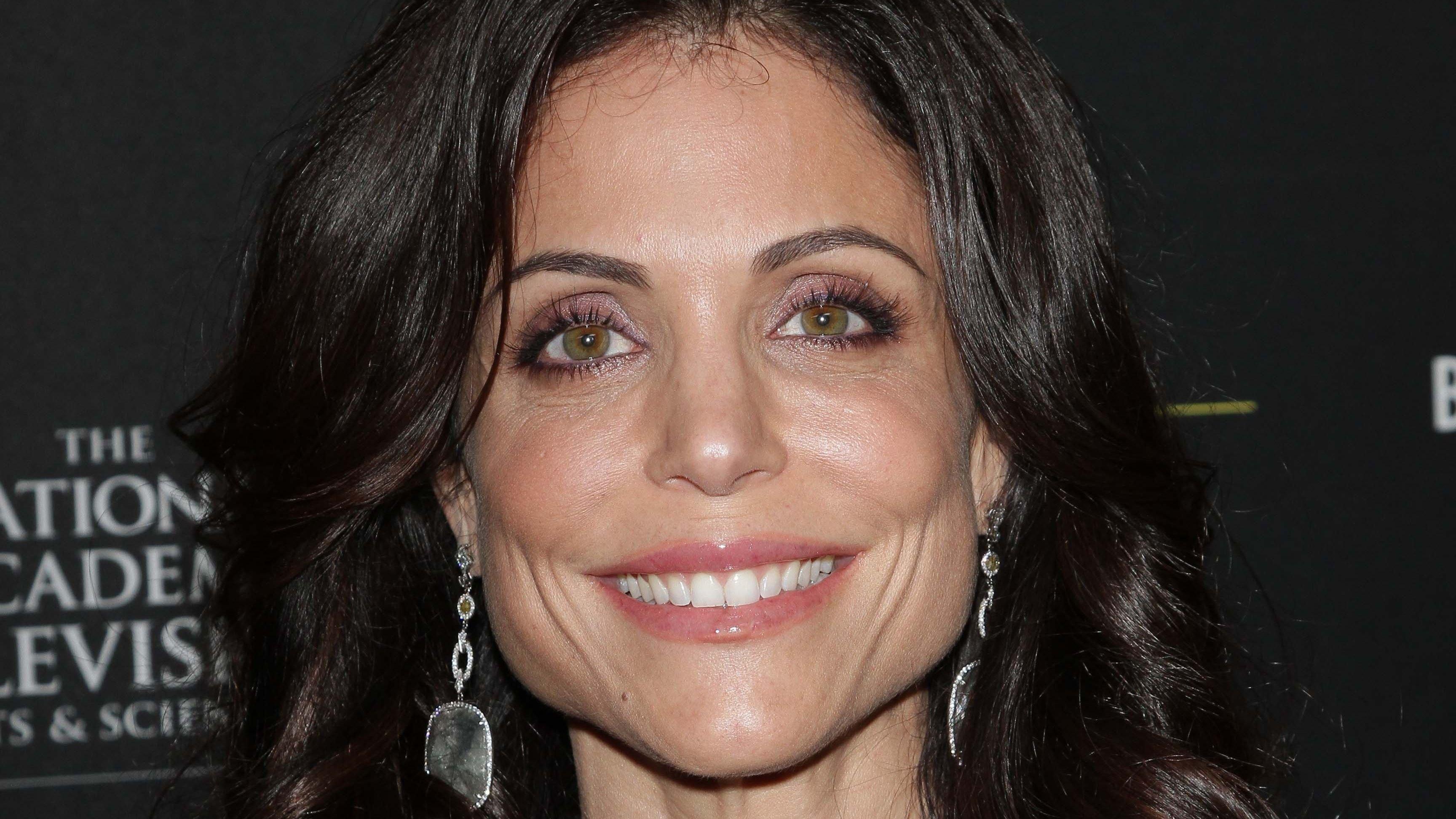 Bethenny Frankel smiles with curled hair