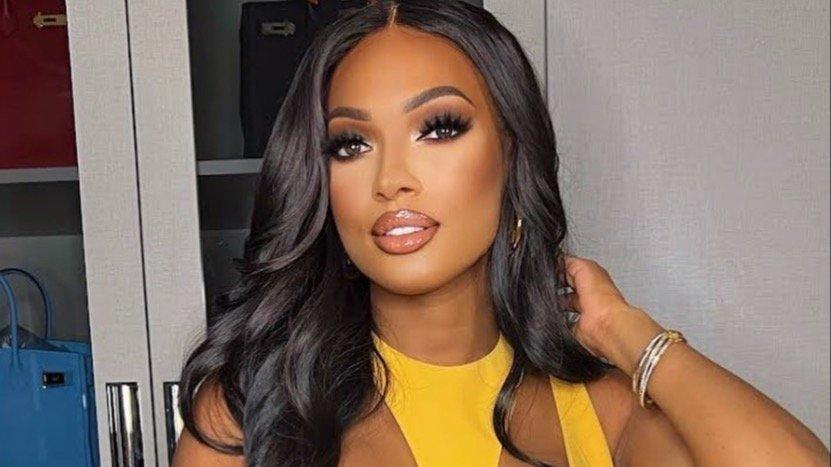 Lesa Milan wears yellow halter with curled hair