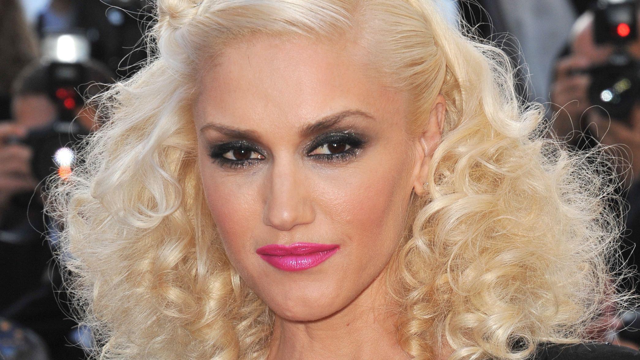 Gwen Stefani with curly hair and pink lipstick