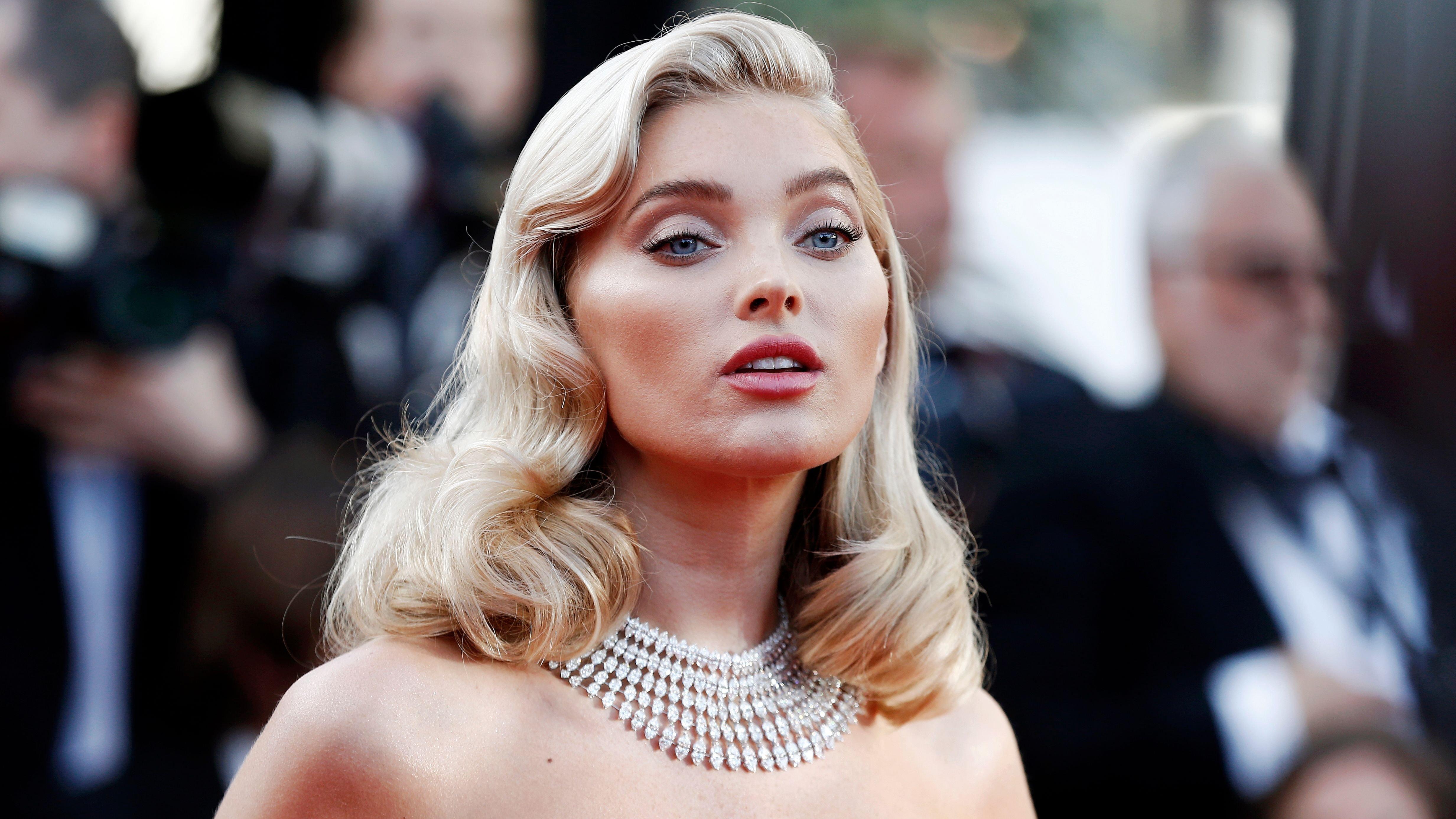 Elsa Hosk exudes Old Hollywood glam in strapless dress, curls, and statement necklace on the red carpet.