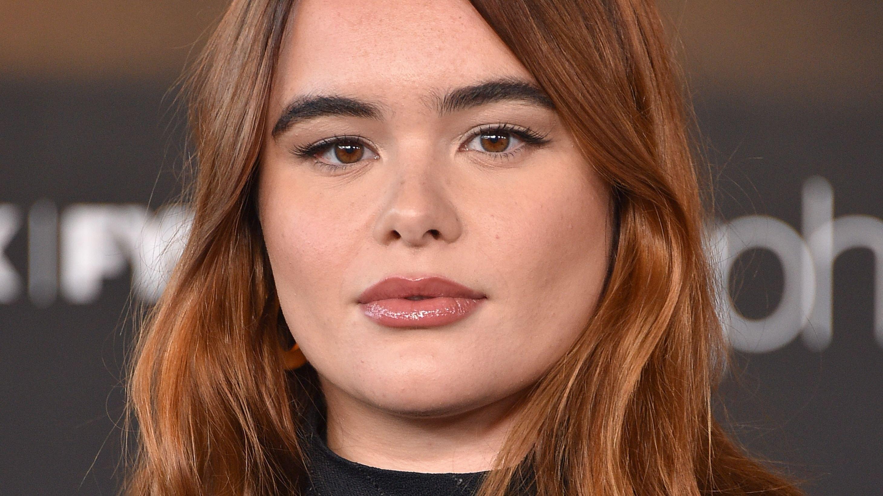 Barbie Ferreira rocks black turtleneck and wavy hair at an event.