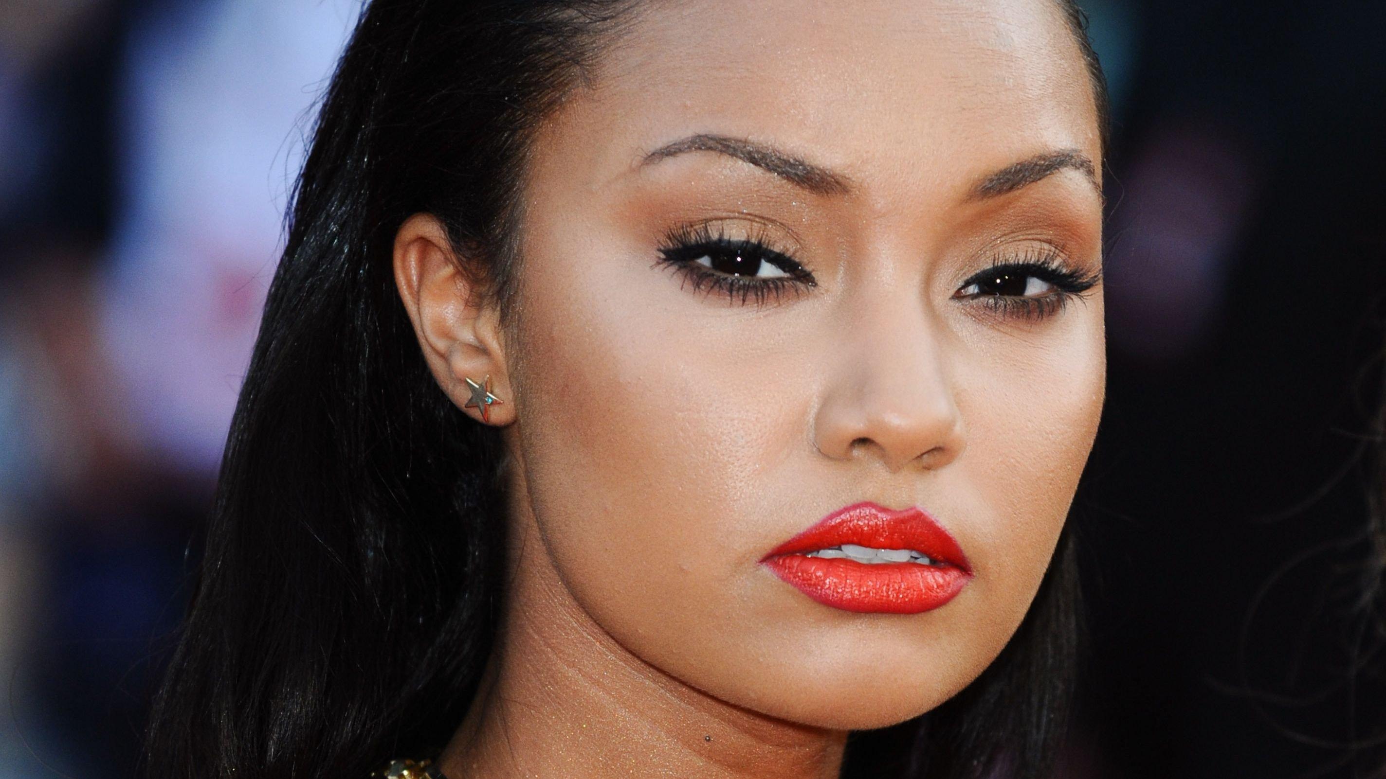 Leigh-Anne Pinnock wears bold red lip, slicked-back hair, and chunky gold chain at an event.